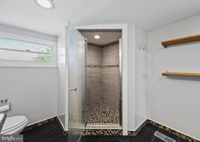 a view of bathroom with a sink and mirror