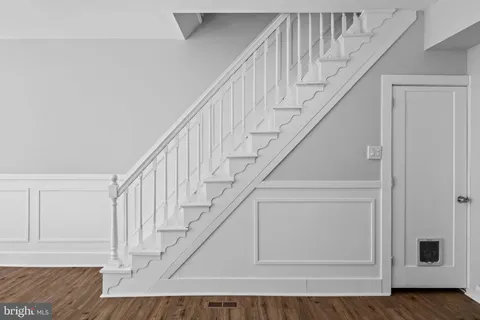a kitchen with stainless steel appliances granite countertop white cabinets and black stove top oven