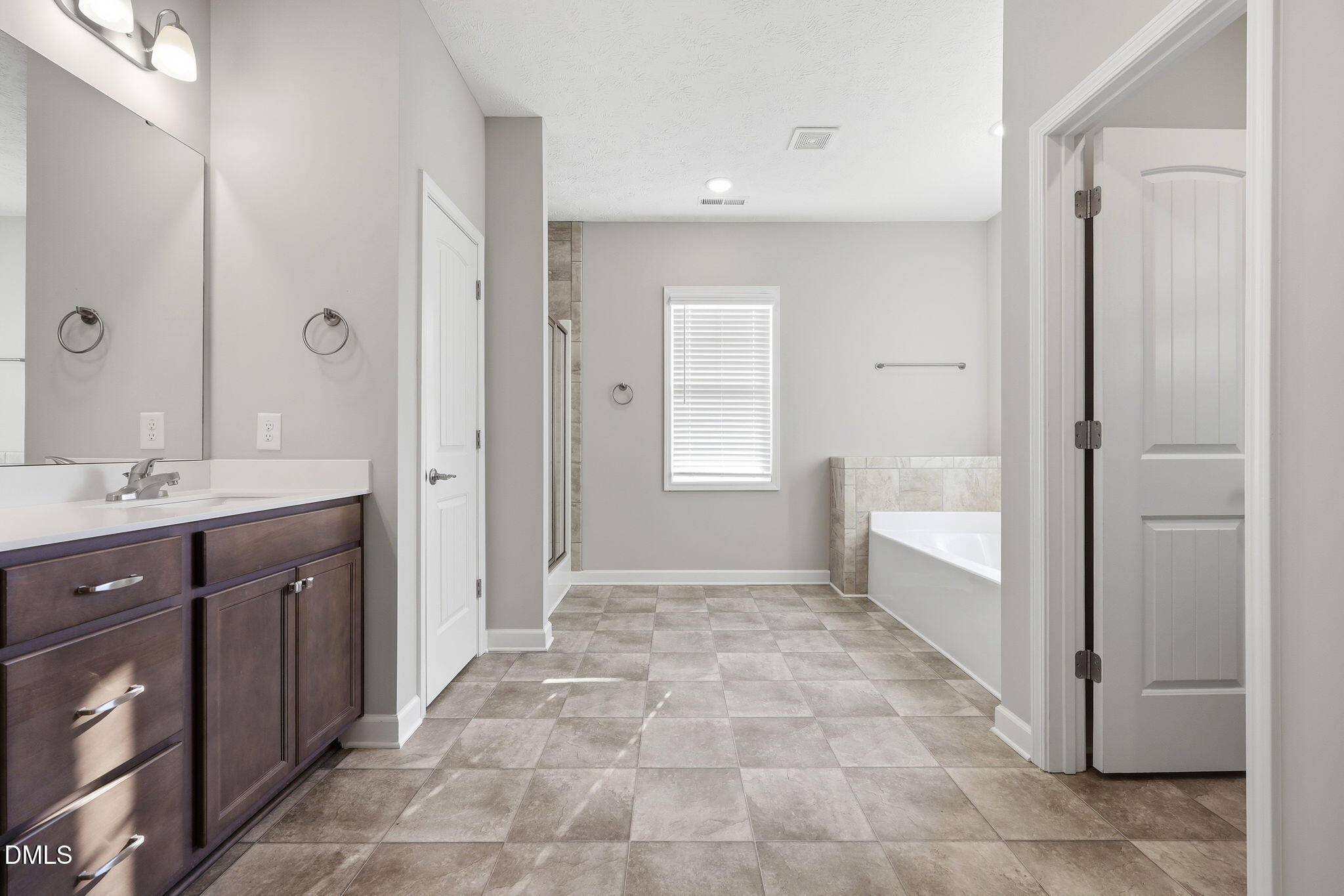 3017 Branscombe Road Fayetteville, NC 28304 - Photo 17 of 43 a bathroom with a sink a mirror and a shower