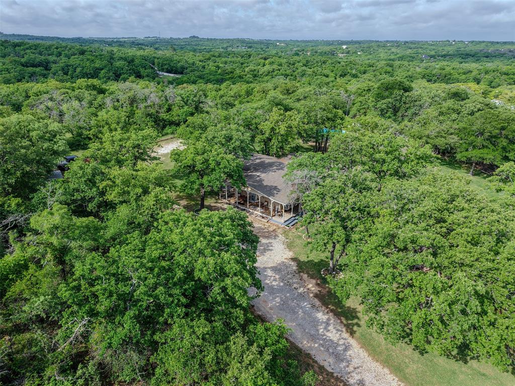 309 Tejas Trail Springtown, TX 76082 - Photo 39 of 40 a view of a garden with a building