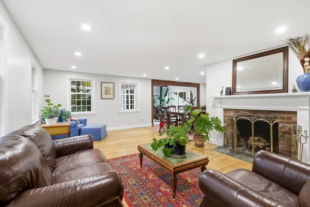 a dining room with furniture potted plants and wooden floor