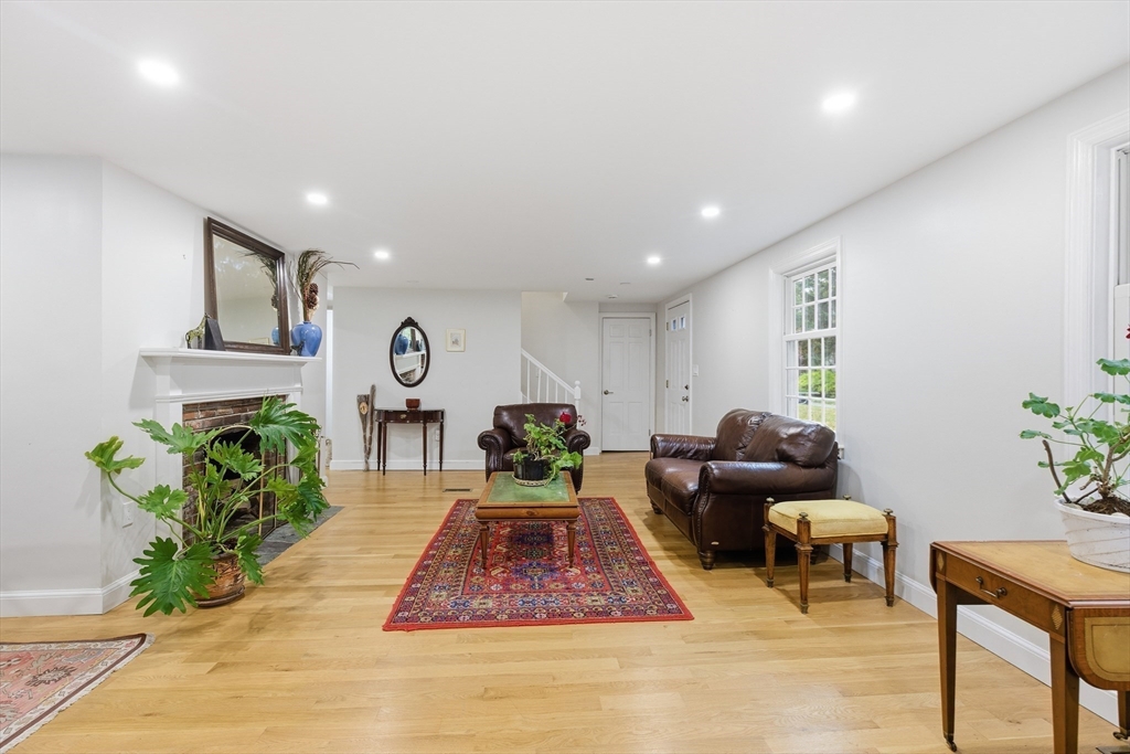 24 Woodland Road Sudbury, MA 01776 - Photo 15 of 42 a living room with furniture and a potted plant