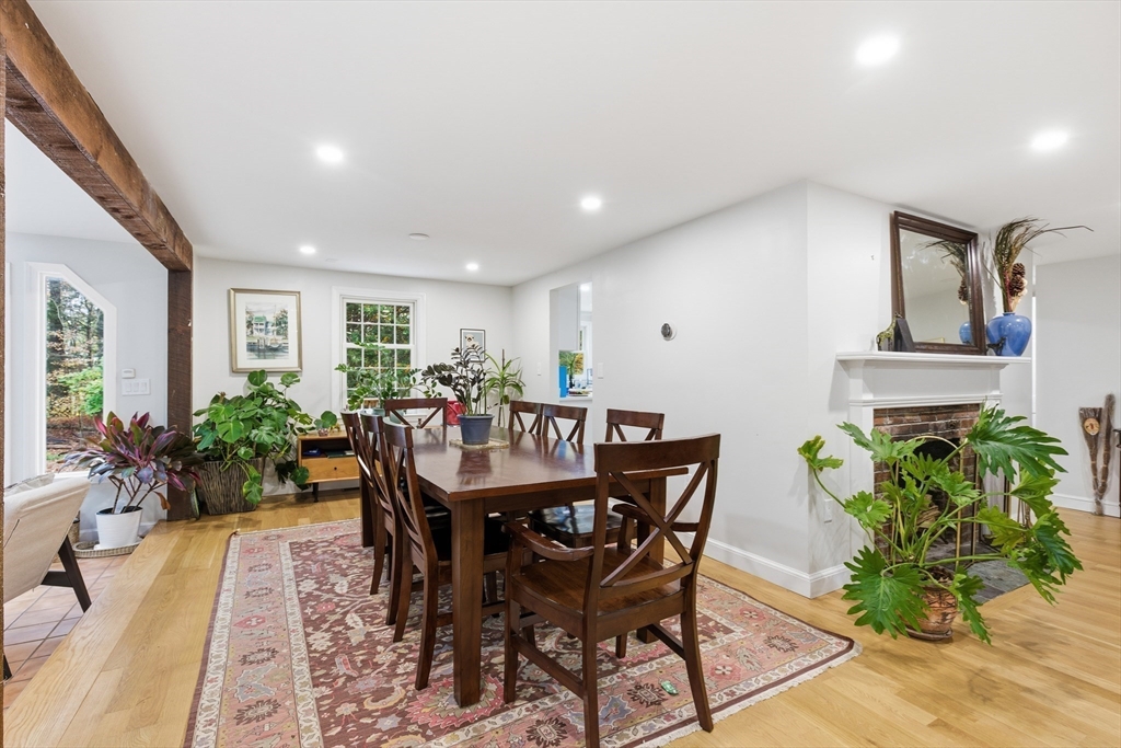 24 Woodland Road Sudbury, MA 01776 - Photo 18 of 42 a dining room with furniture potted plants and wooden floor