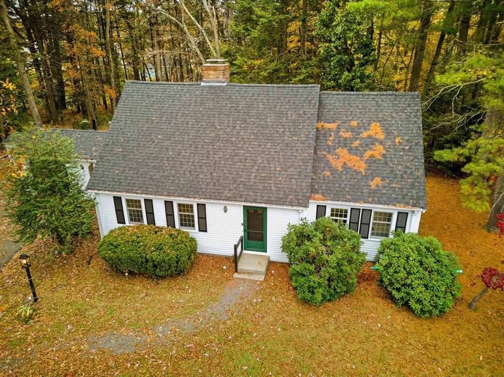 24 Woodland Road Sudbury, MA 01776 - Photo 2 of 42 an aerial view of a house with yard and trees in the background