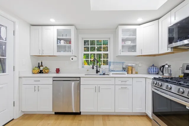 a bathroom with a toilet a sink and a window