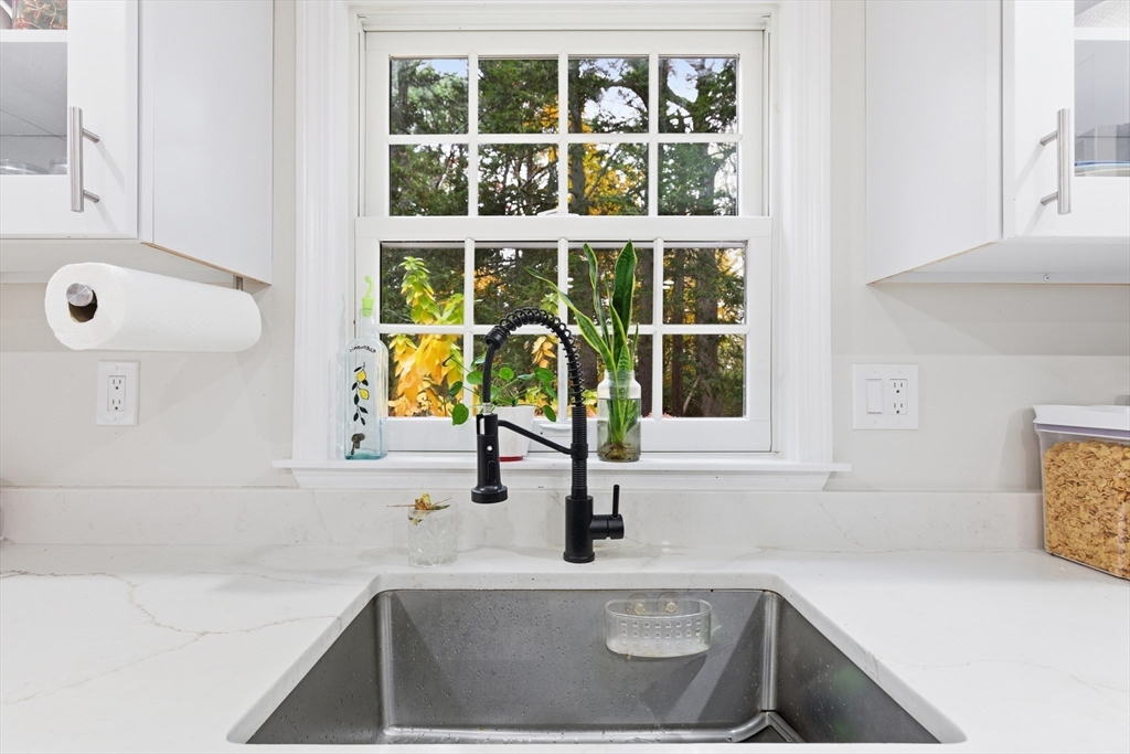 24 Woodland Road Sudbury, MA 01776 - Photo 24 of 42 a kitchen with a sink a faucet and a window