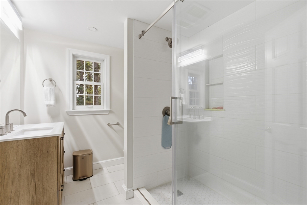 24 Woodland Road Sudbury, MA 01776 - Photo 27 of 42 a bathroom with a sink a toilet and shower