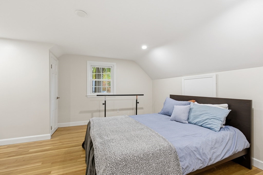 24 Woodland Road Sudbury, MA 01776 - Photo 29 of 42 a bedroom with a bed and a window