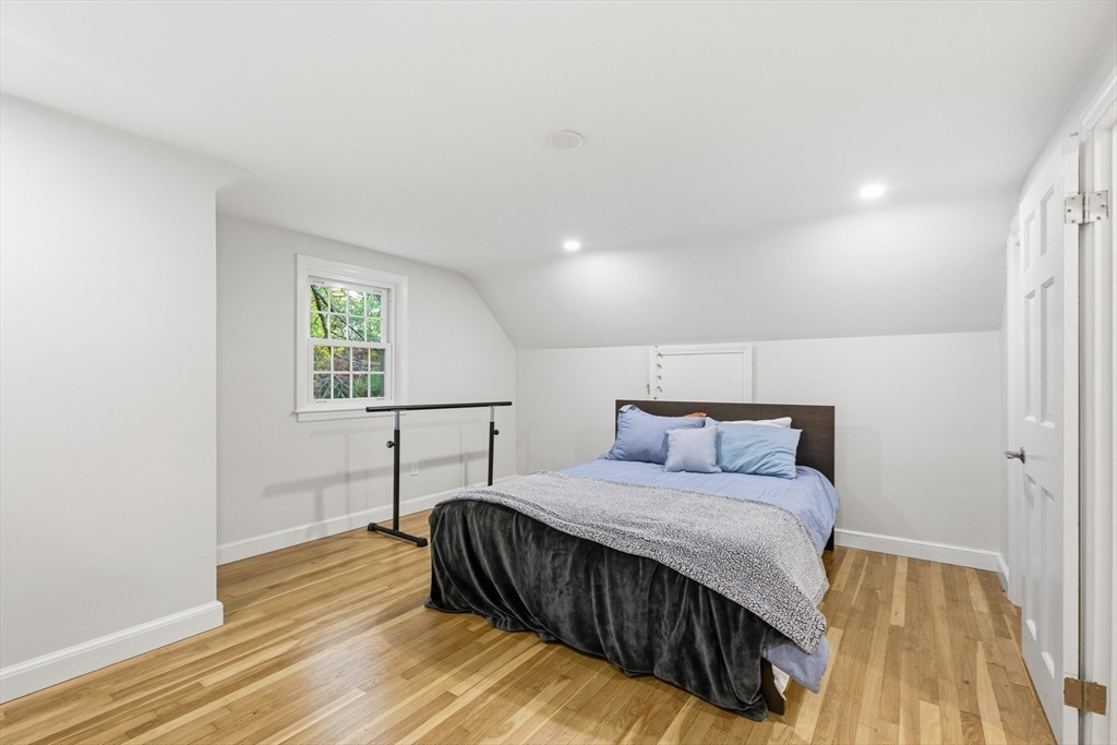 24 Woodland Road Sudbury, MA 01776 - Photo 30 of 42 a bedroom with a bed and a table