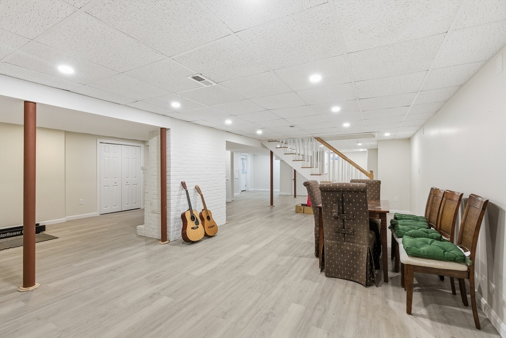 24 Woodland Road Sudbury, MA 01776 - Photo 35 of 42 a dining room with furniture and a wooden floor