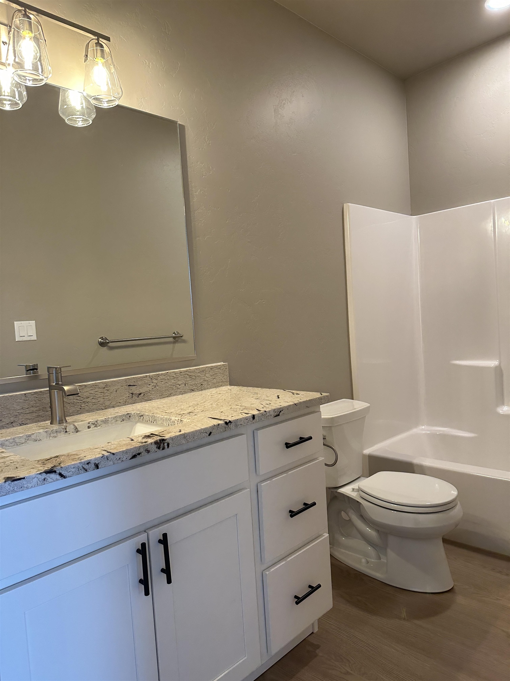 2456 Ross Road Grand Junction, CO 81505 - Photo 4 of 11 a bathroom with a granite countertop sink toilet and mirror