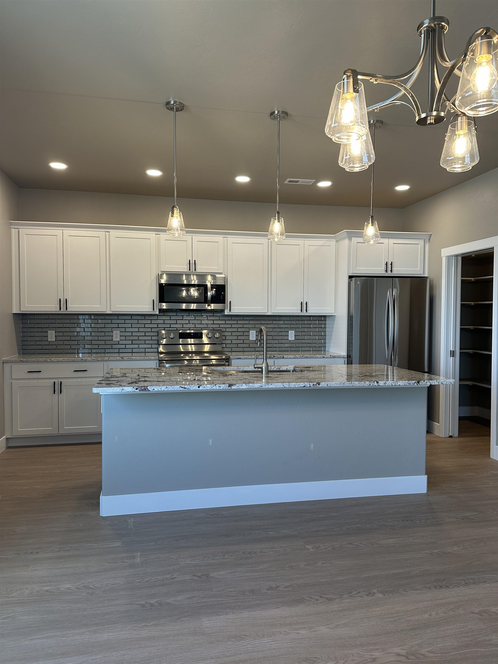 2456 Ross Road Grand Junction, CO 81505 - Photo 8 of 11 a view of a kitchen with a sink and chandelier