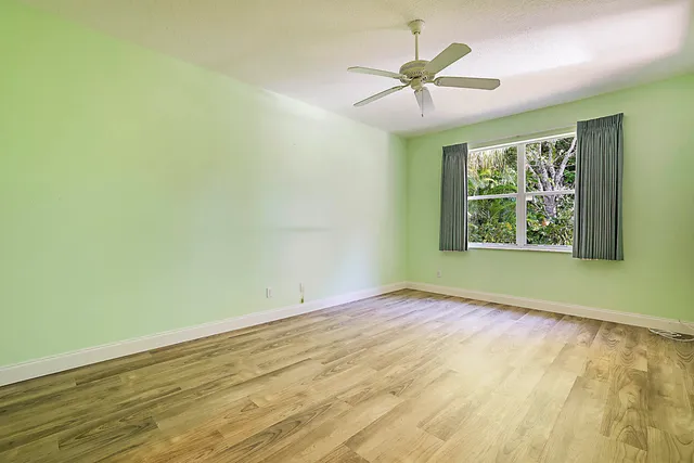 a view of room with window and ceiling fan