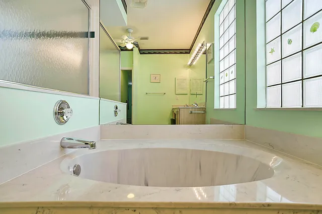 a bathroom with a tub and shower