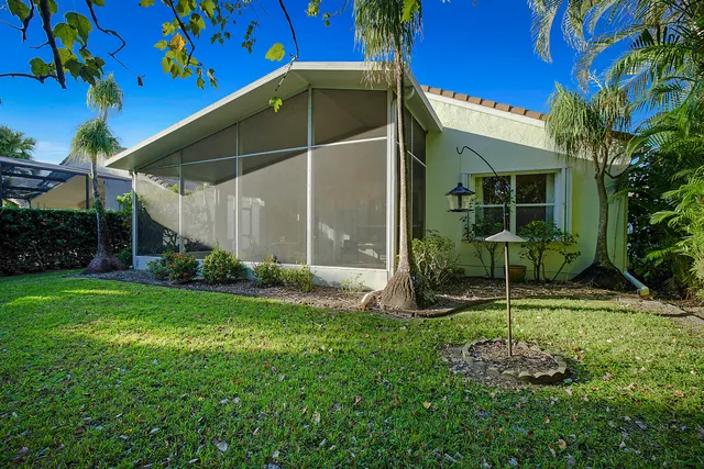 a view of a chair and table in backyard of the house