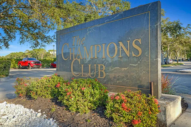 a view of sign board with potted plants