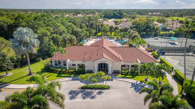 an aerial view of a house with swimming pool and garden