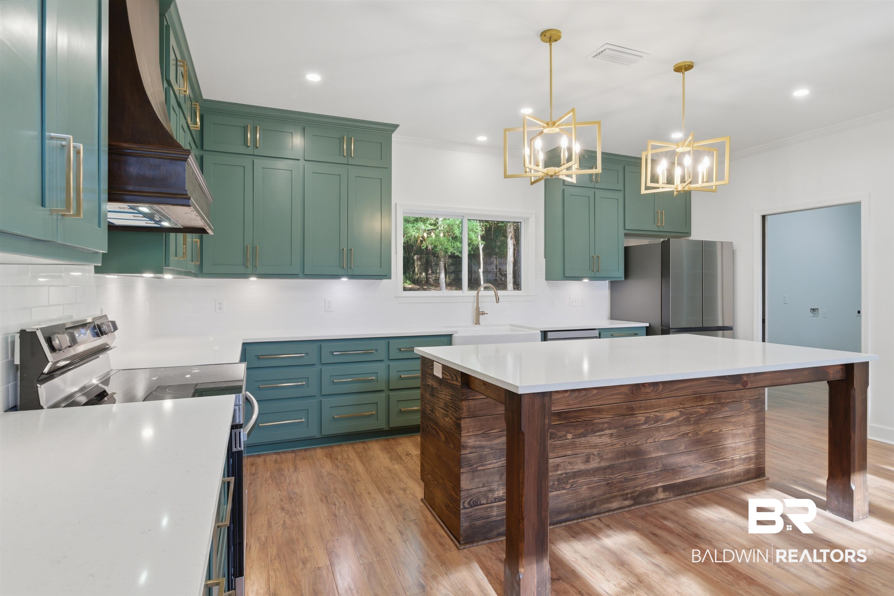 14128 Jackson Lane Foley, AL 36535 - Photo 12 of 36 Kitchen featuring teal cabinetry, white subway tile backsplash, white countertops, stainless steel appliances, and a wood-finish island with a white countertop