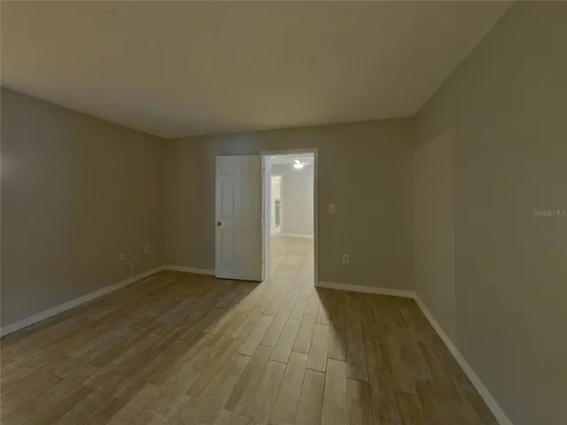 a view of an empty room and wooden floor