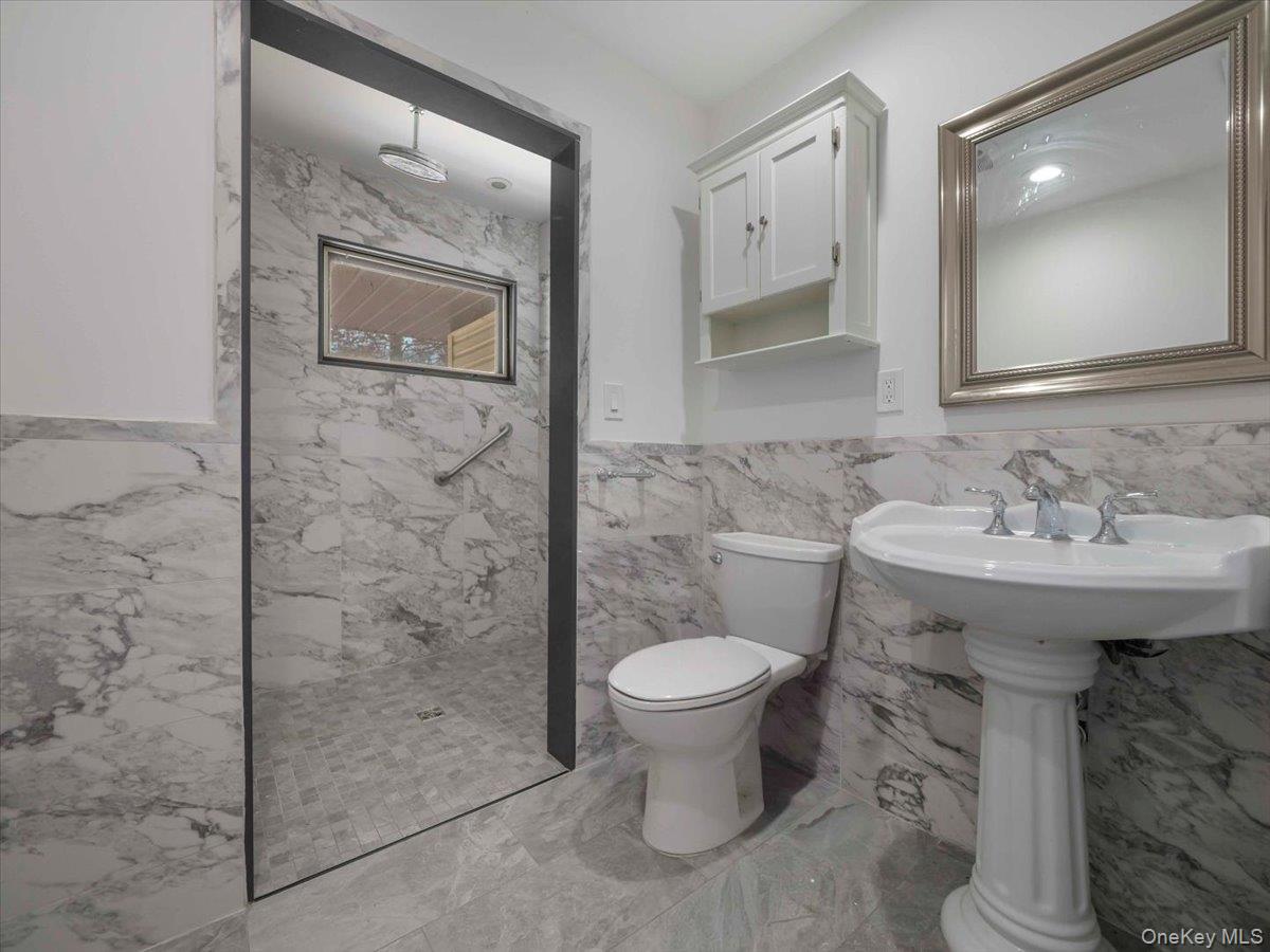 61 Rolling Ridge Road New City, NY 10956 - Photo 15 of 43 a bathroom with a sink toilet and shower