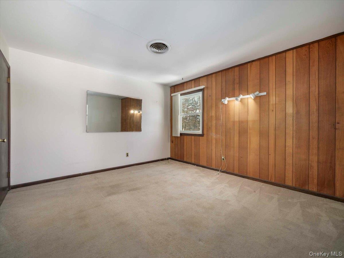 61 Rolling Ridge Road New City, NY 10956 - Photo 18 of 43 a view of an empty room with a window