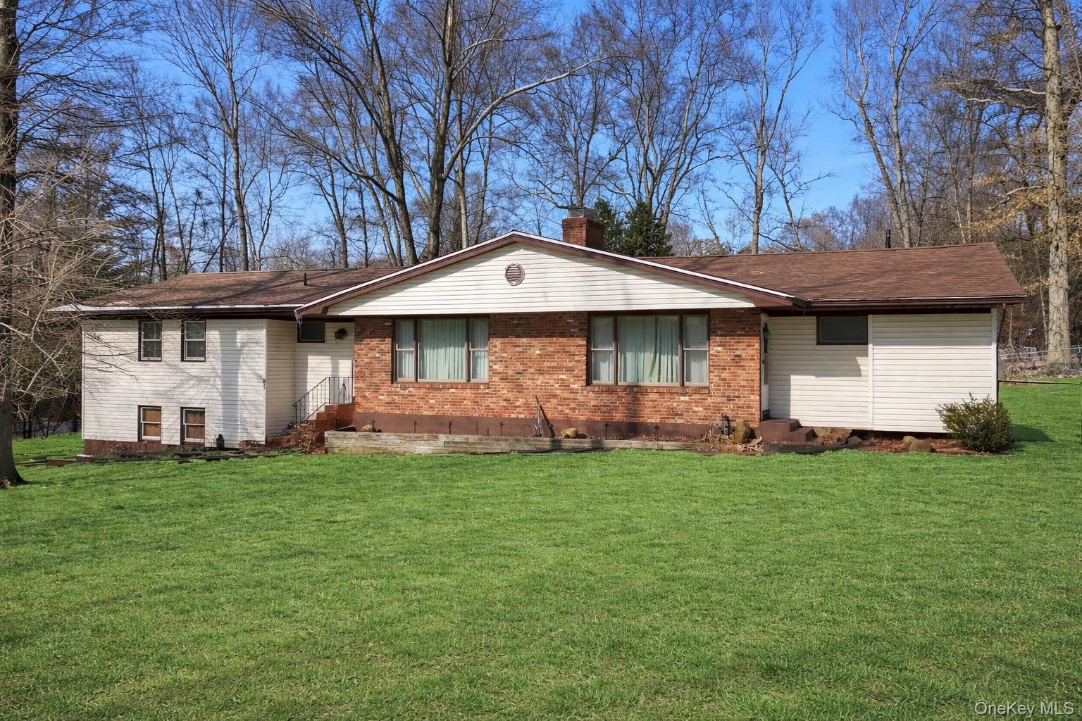 61 Rolling Ridge Road New City, NY 10956 - Photo 2 of 43 a front view of a house with a garden