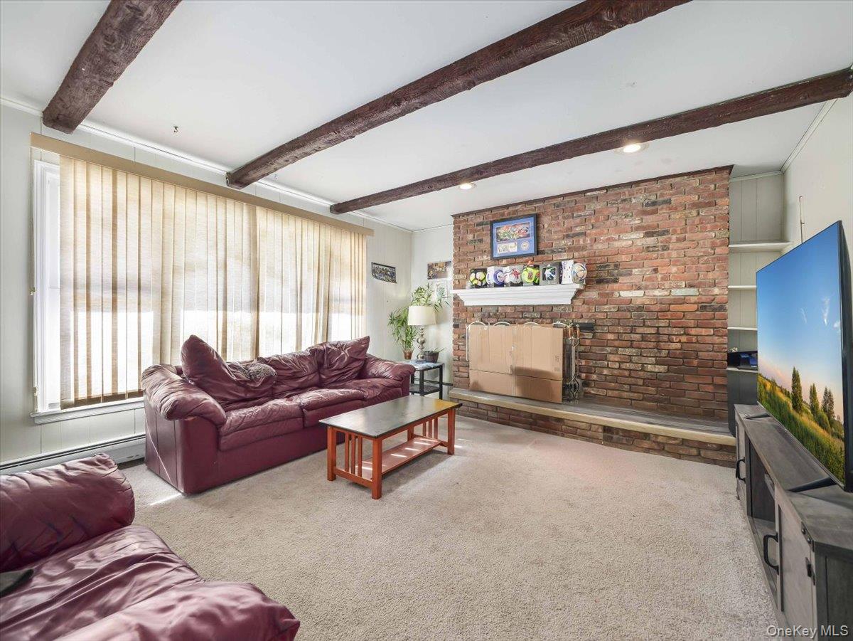 61 Rolling Ridge Road New City, NY 10956 - Photo 34 of 43 a living room with furniture a flat screen tv and a fireplace
