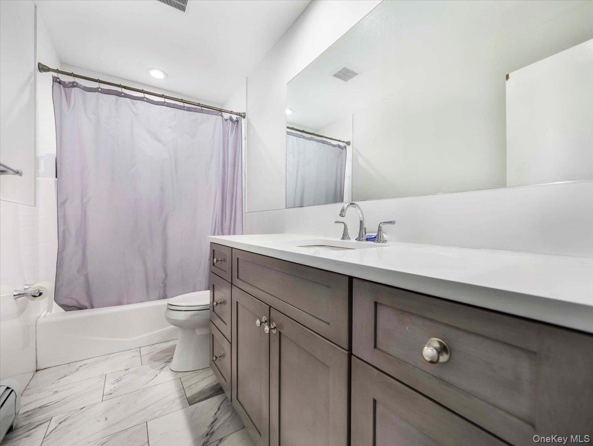 61 Rolling Ridge Road New City, NY 10956 - Photo 43 of 43 a bathroom with a sink a toilet a mirror and shower