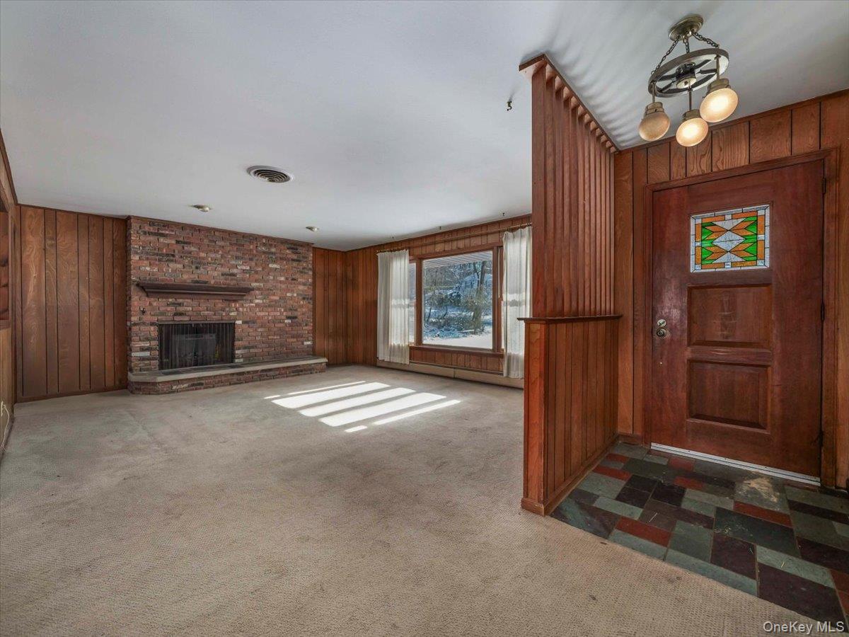 61 Rolling Ridge Road New City, NY 10956 - Photo 5 of 43 an empty room with windows cabinet and fireplace