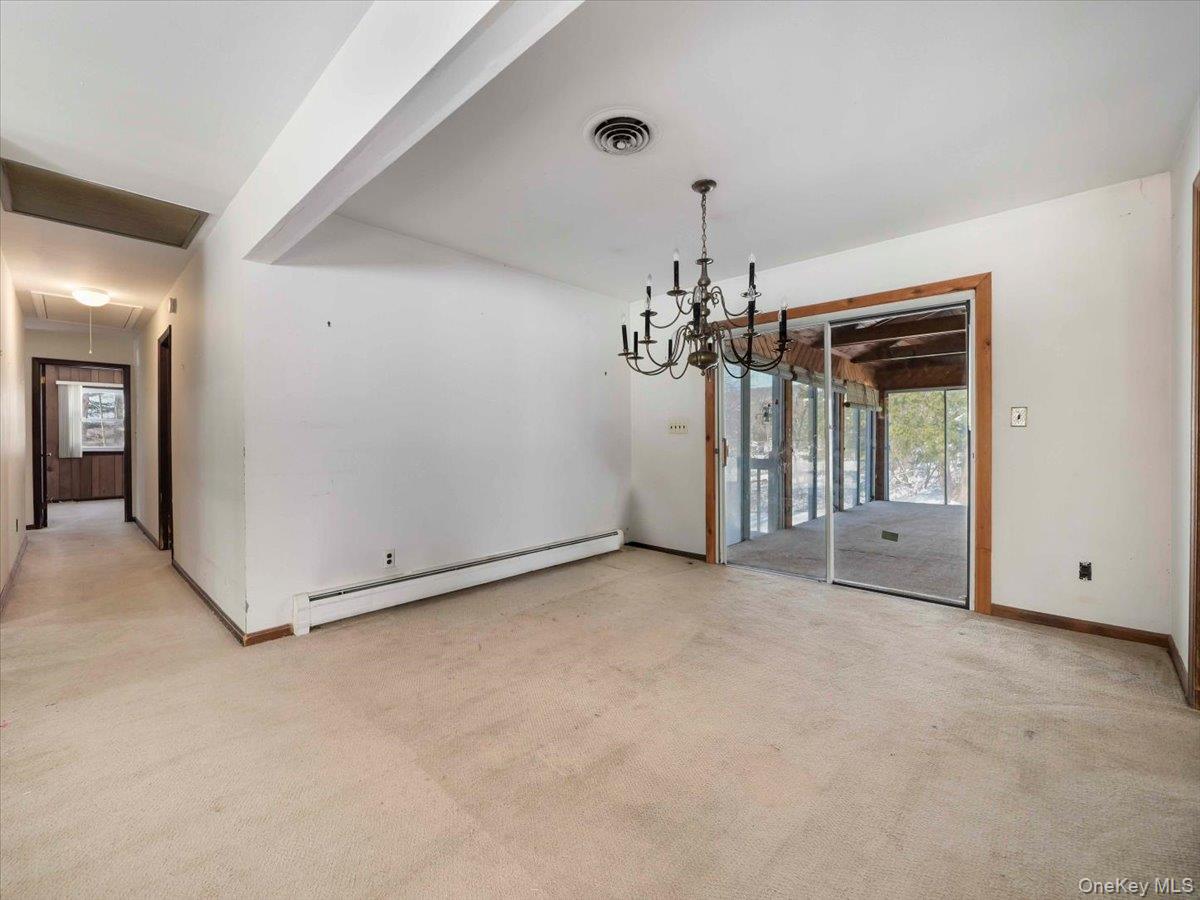 61 Rolling Ridge Road New City, NY 10956 - Photo 8 of 42 Dining Room showing sliders to the 3 season room with knotty pine wood