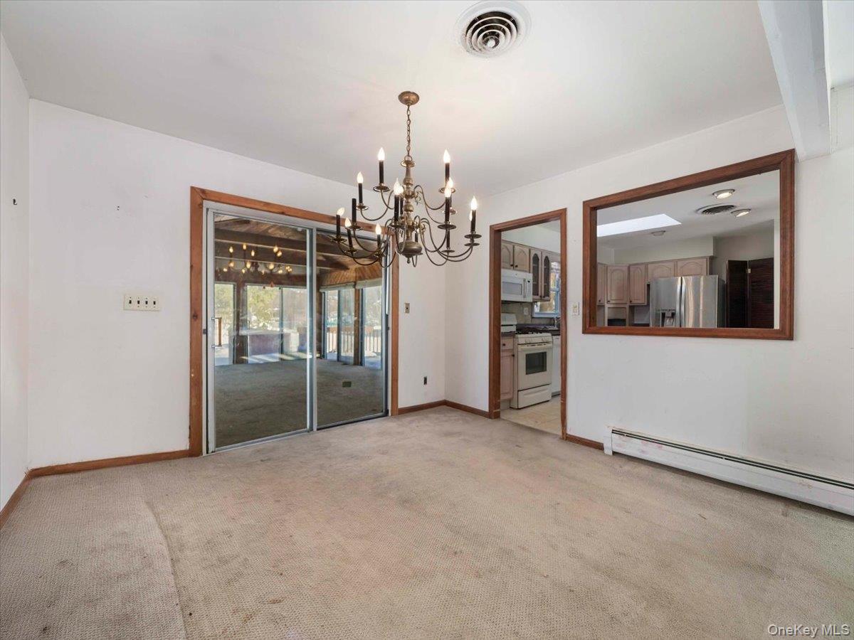 61 Rolling Ridge Road New City, NY 10956 - Photo 10 of 43 en empty room with chandelier and glass door