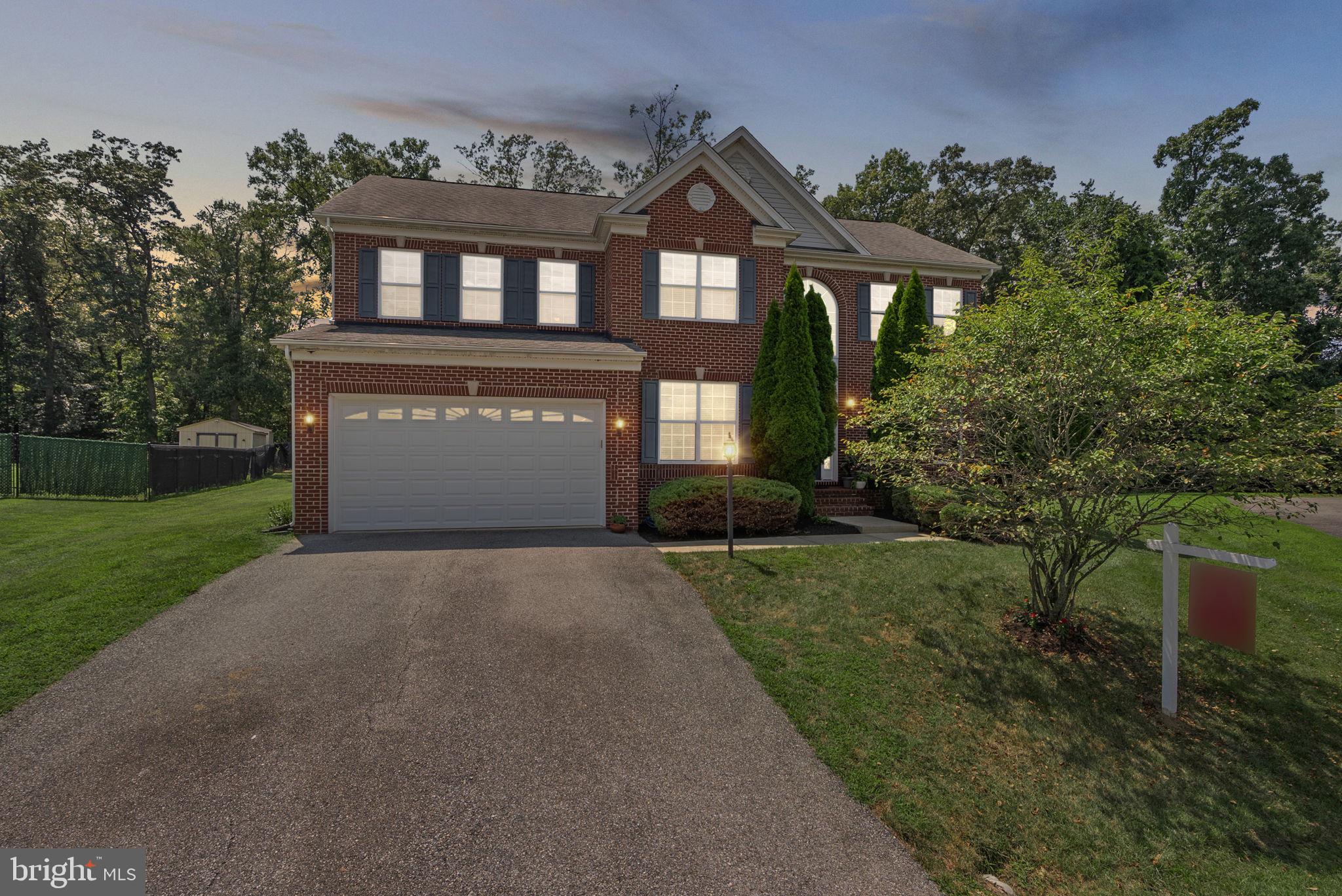 8301 Cedar View Court Clinton, MD 20735 - Photo 2 of 32 a front view of a house with a yard and garage