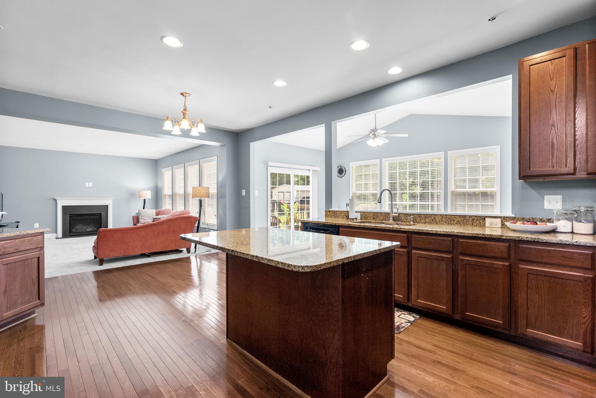 8301 Cedar View Court Clinton, MD 20735 - Photo 6 of 32 a kitchen with stainless steel appliances granite countertop wooden floors and view living room
