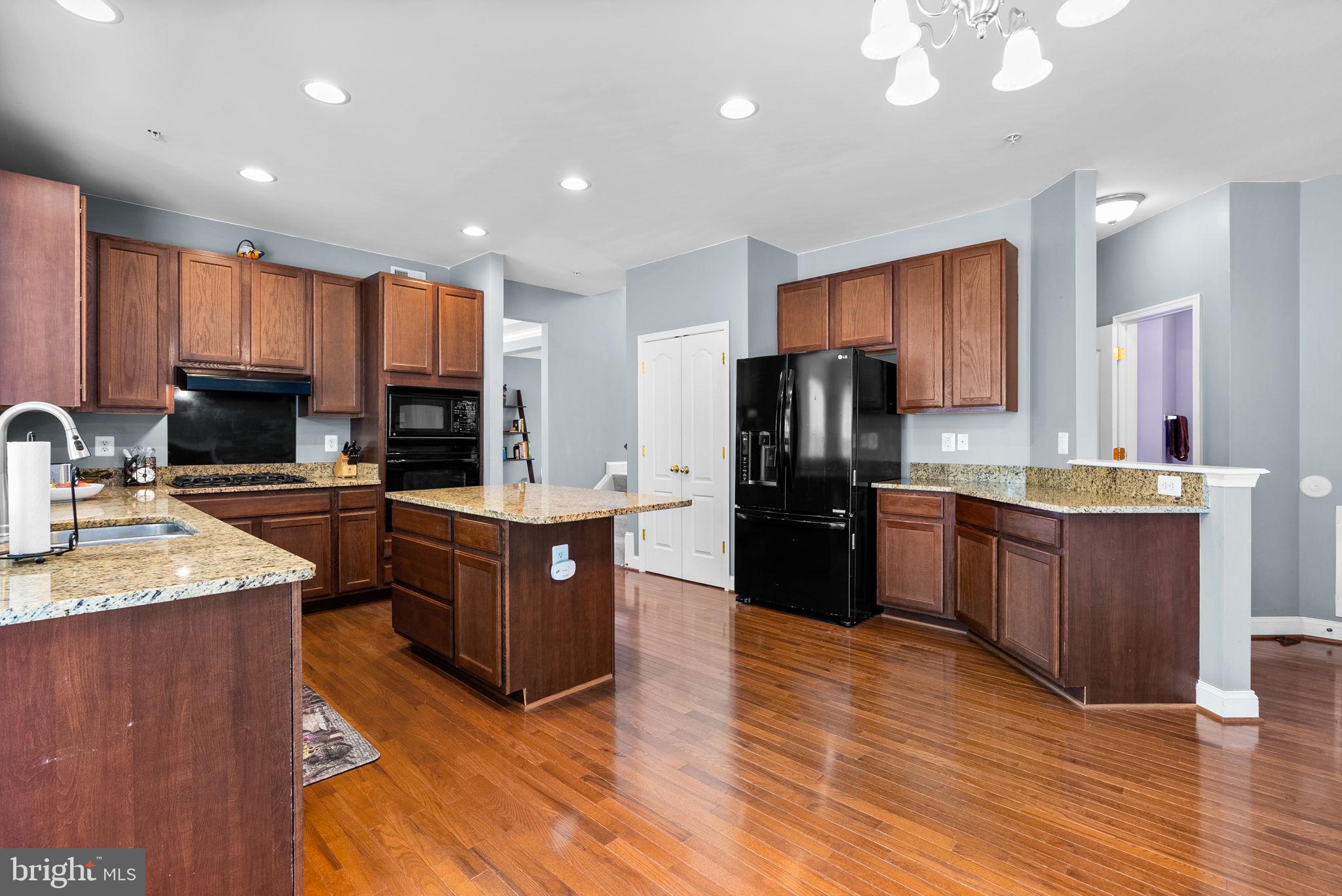 8301 Cedar View Court Clinton, MD 20735 - Photo 7 of 32 a kitchen with stainless steel appliances wooden cabinets a refrigerator a stove a sink and a oven