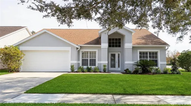 a front view of a house with a garden and yard