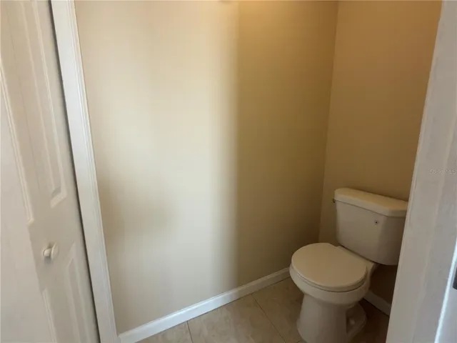 a white toilet sitting next to a shower