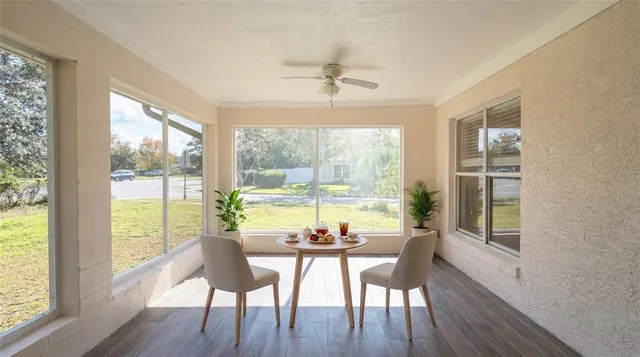 a view of a dining room with furniture window and wooden floor