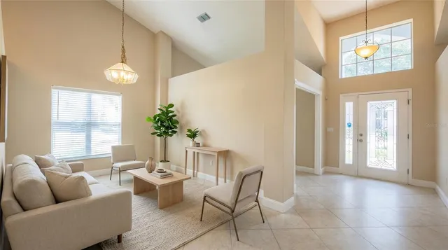 a living room with furniture and a chandelier