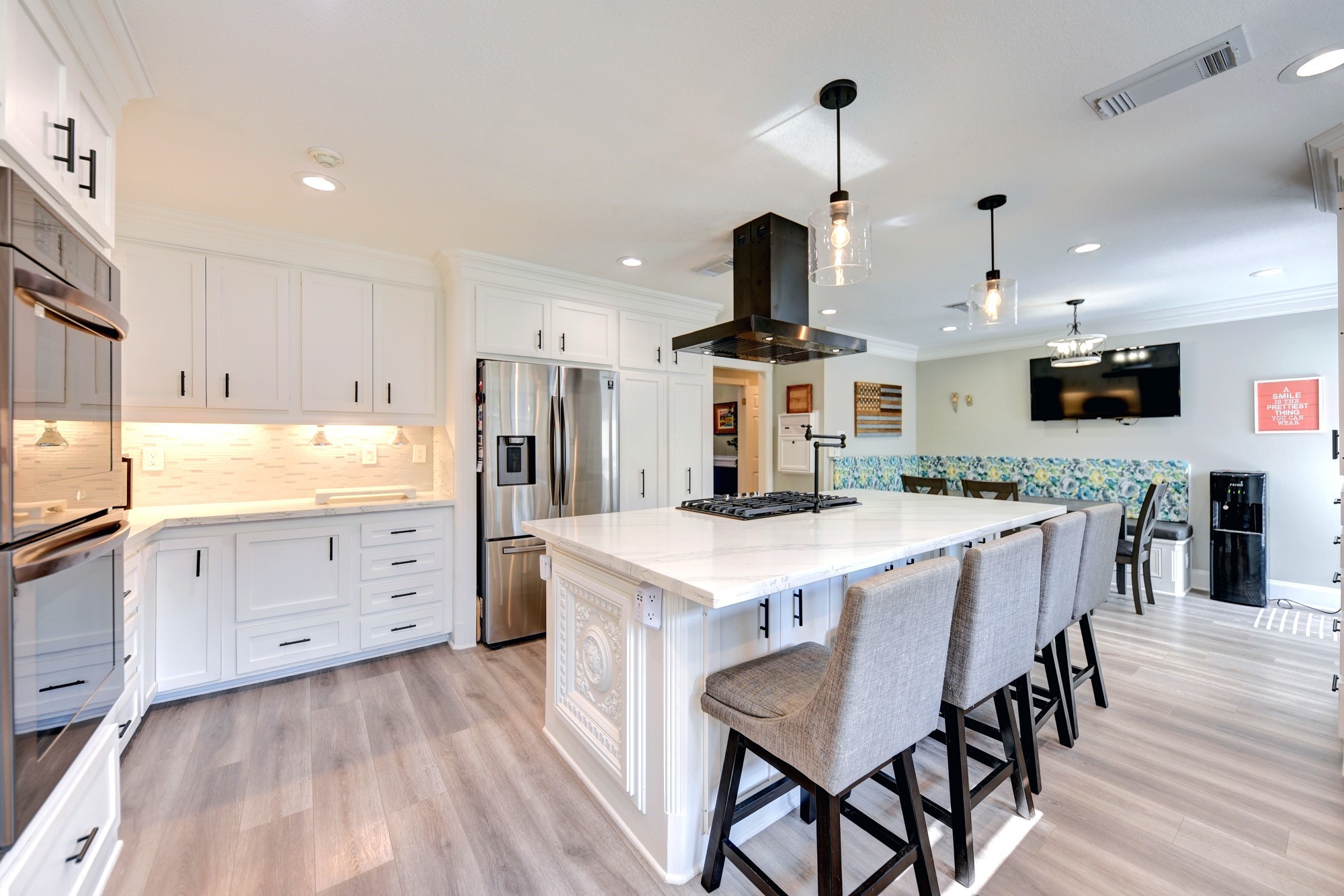 1950 Country Club Road Brenham, TX 77833 - Photo 14 of 39 a kitchen with stainless steel appliances kitchen island granite countertop a table chairs sink and cabinets