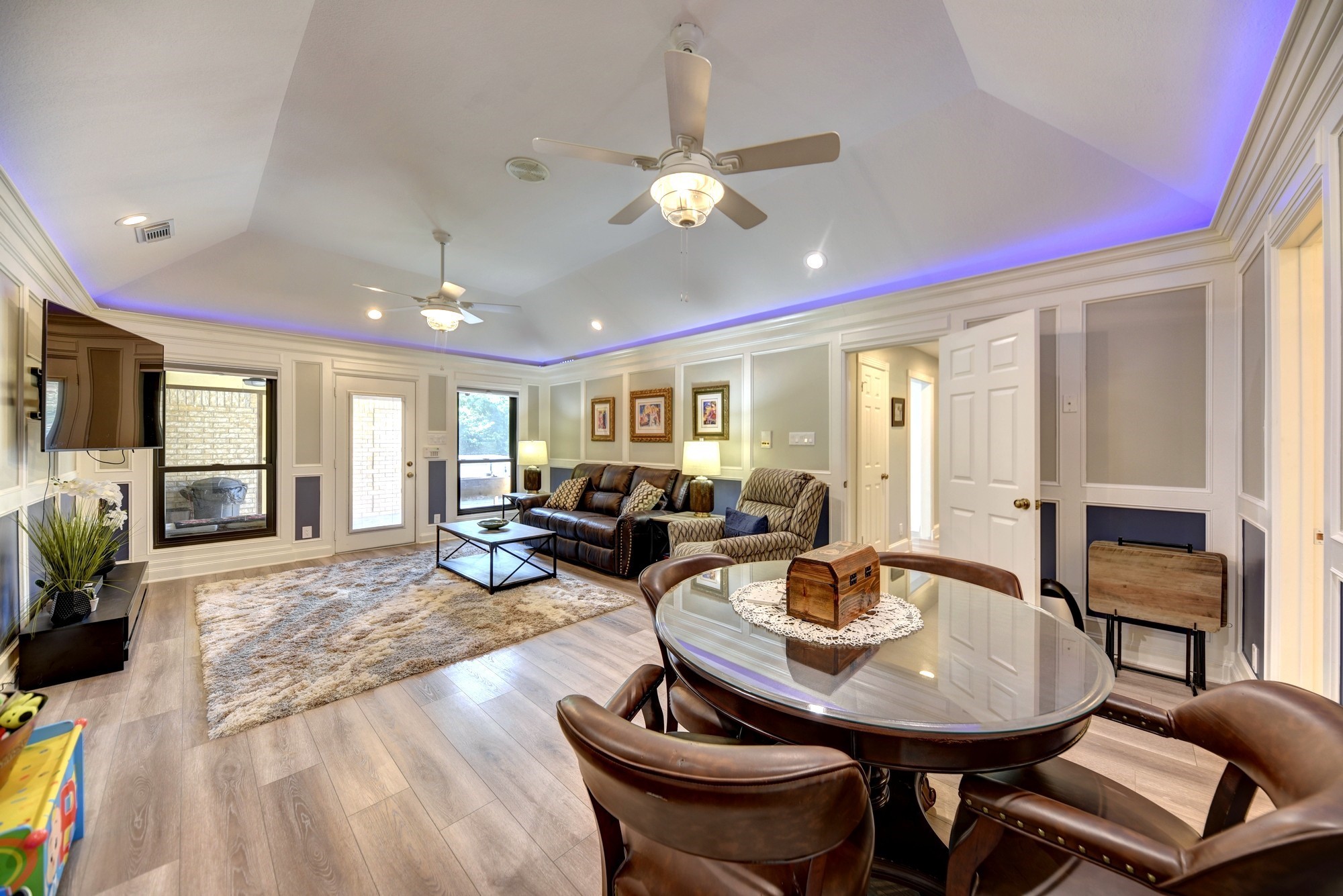 1950 Country Club Road Brenham, TX 77833 - Photo 23 of 39 a living room with furniture a flat screen tv and kitchen view