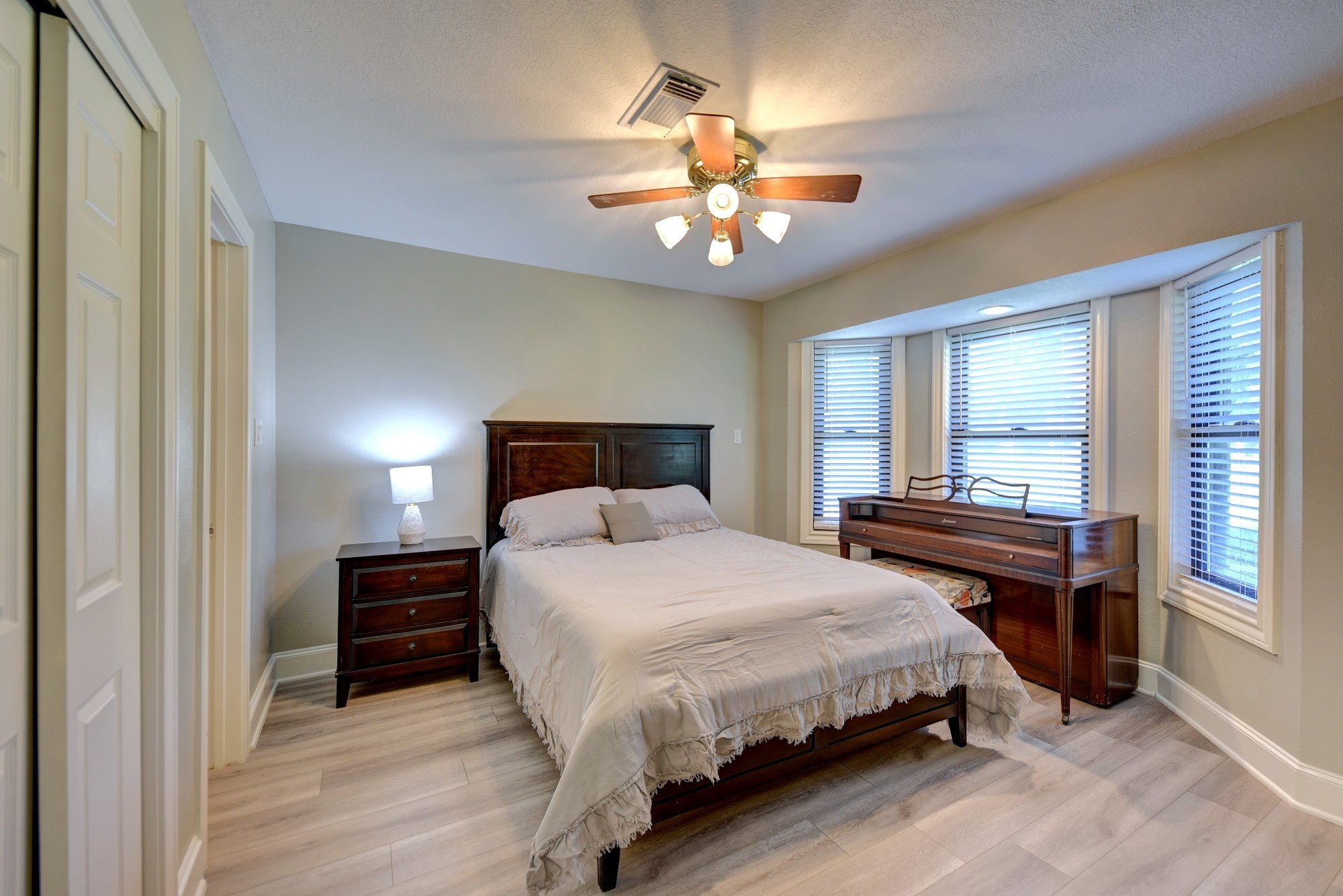 1950 Country Club Road Brenham, TX 77833 - Photo 25 of 39 a bedroom with a large bed and a chandelier
