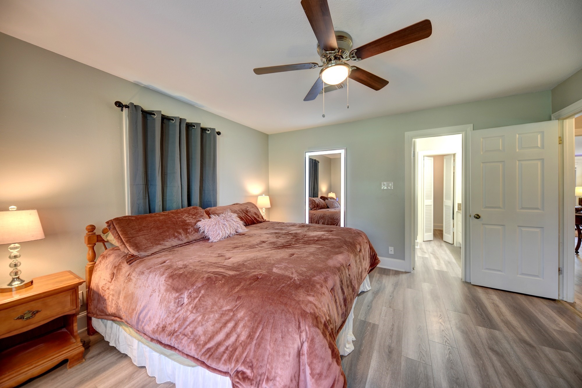 1950 Country Club Road Brenham, TX 77833 - Photo 29 of 39 a spacious bedroom with a bed and a chandelier