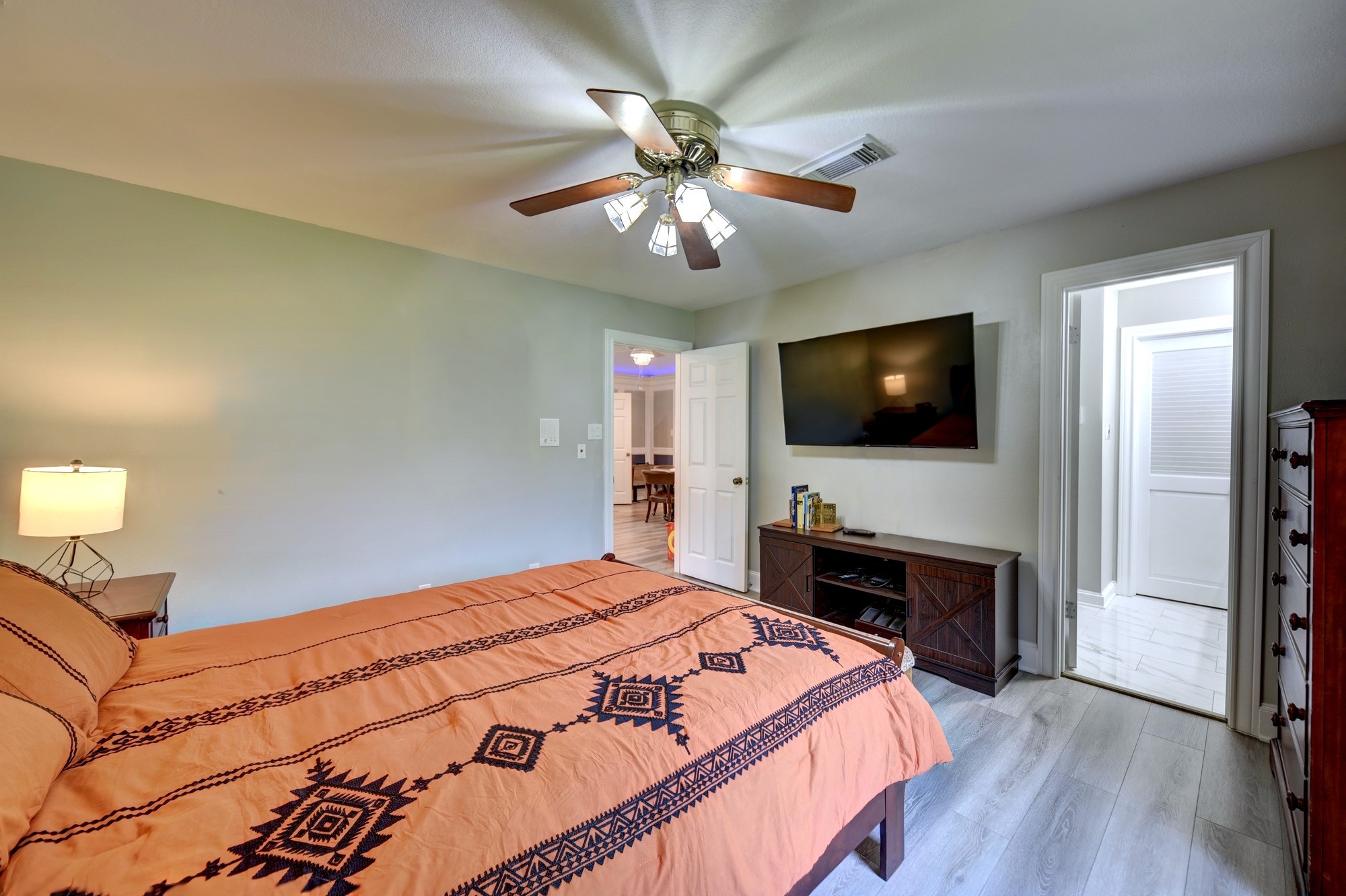 1950 Country Club Road Brenham, TX 77833 - Photo 31 of 39 a bedroom with a bed and a flat screen tv