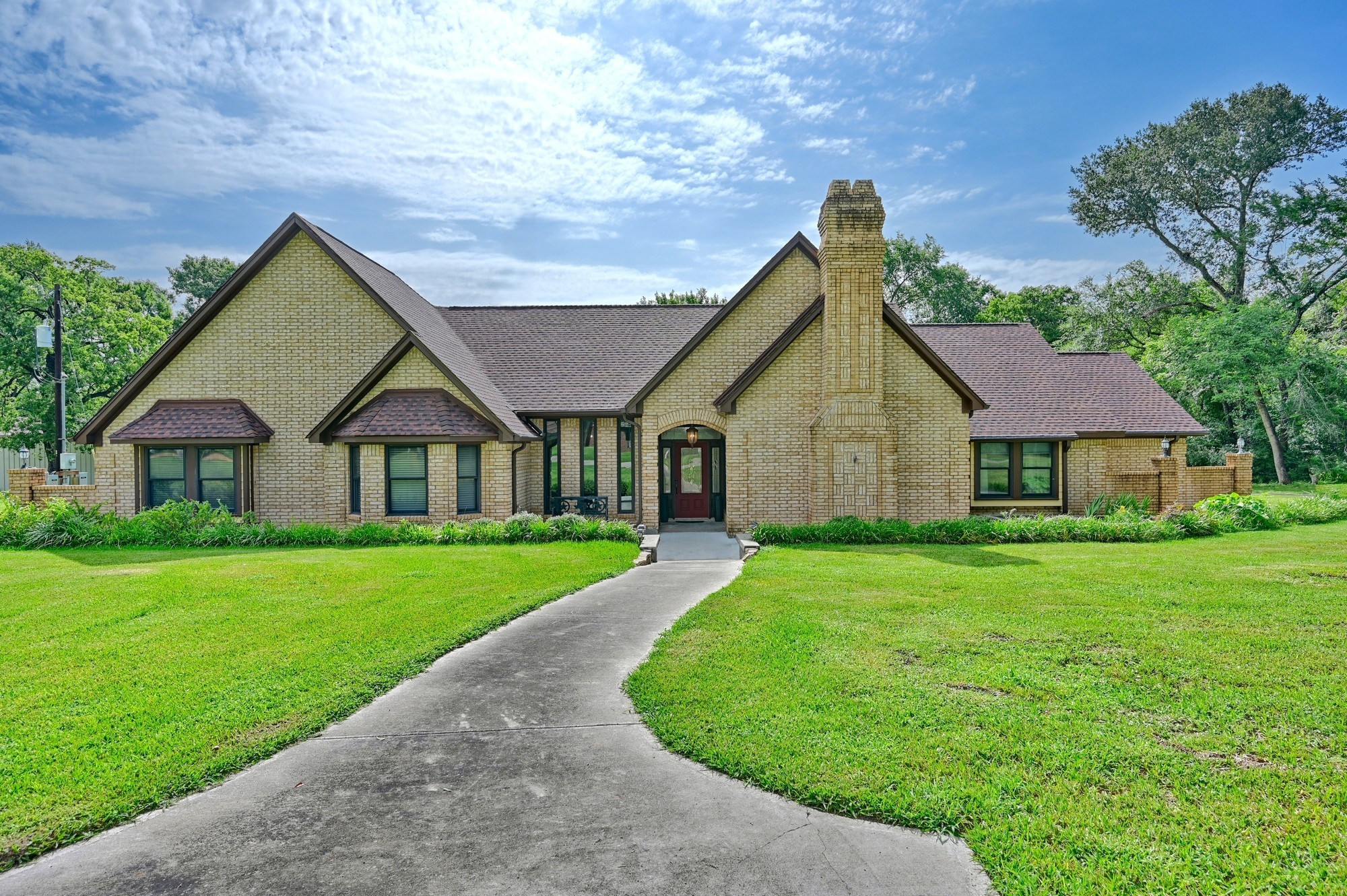 1950 Country Club Road Brenham, TX 77833 - Photo 7 of 39 a front view of a house with a yard and trees