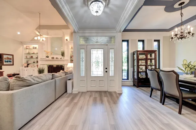a kitchen with stainless steel appliances kitchen island granite countertop a table chairs sink and cabinets