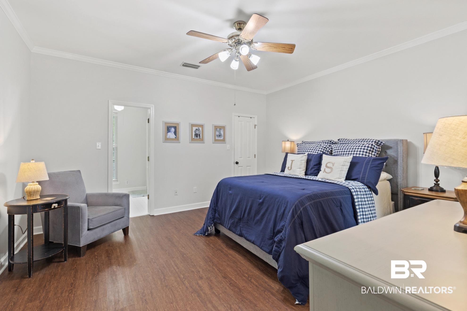 12171 Marguerite Drive Coden, AL 36523 - Photo 13 of 44 Spacious room featuring wood-finish flooring, white walls, and crown molding