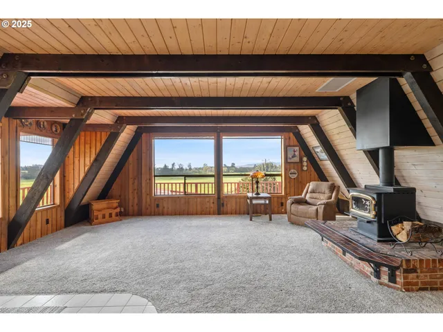 a living room with a large window and furniture