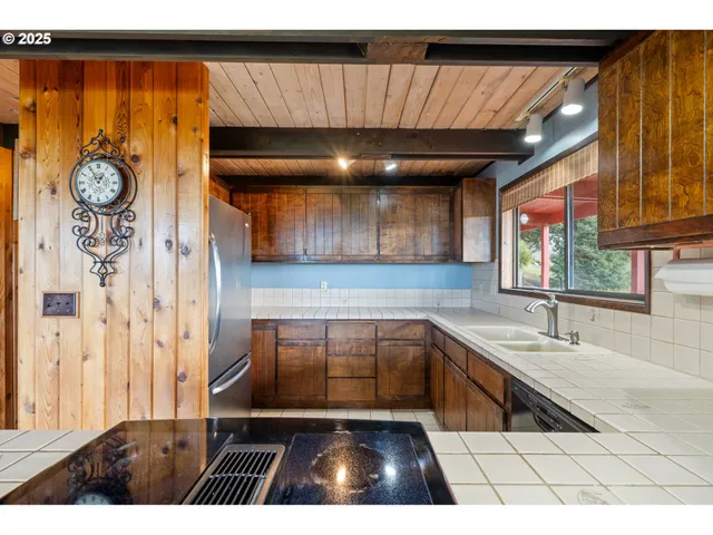 a kitchen with a refrigerator and a sink