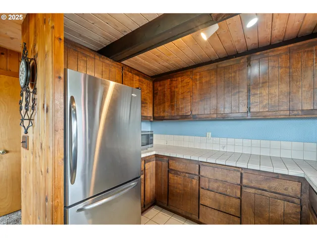 a kitchen with cabinets and stainless steel appliances