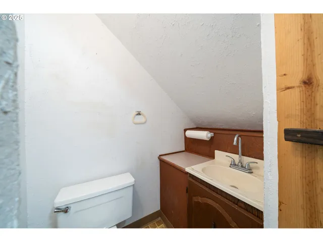 a view of a big room with wooden floor and windows